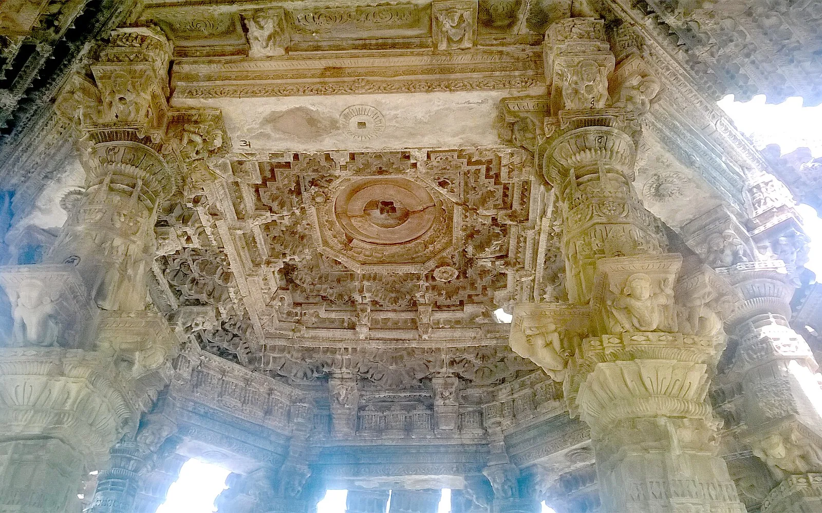 Carved pillars and stepped ceiling inside the hall of the Bhand Devra temple at Ramgarh, Baran